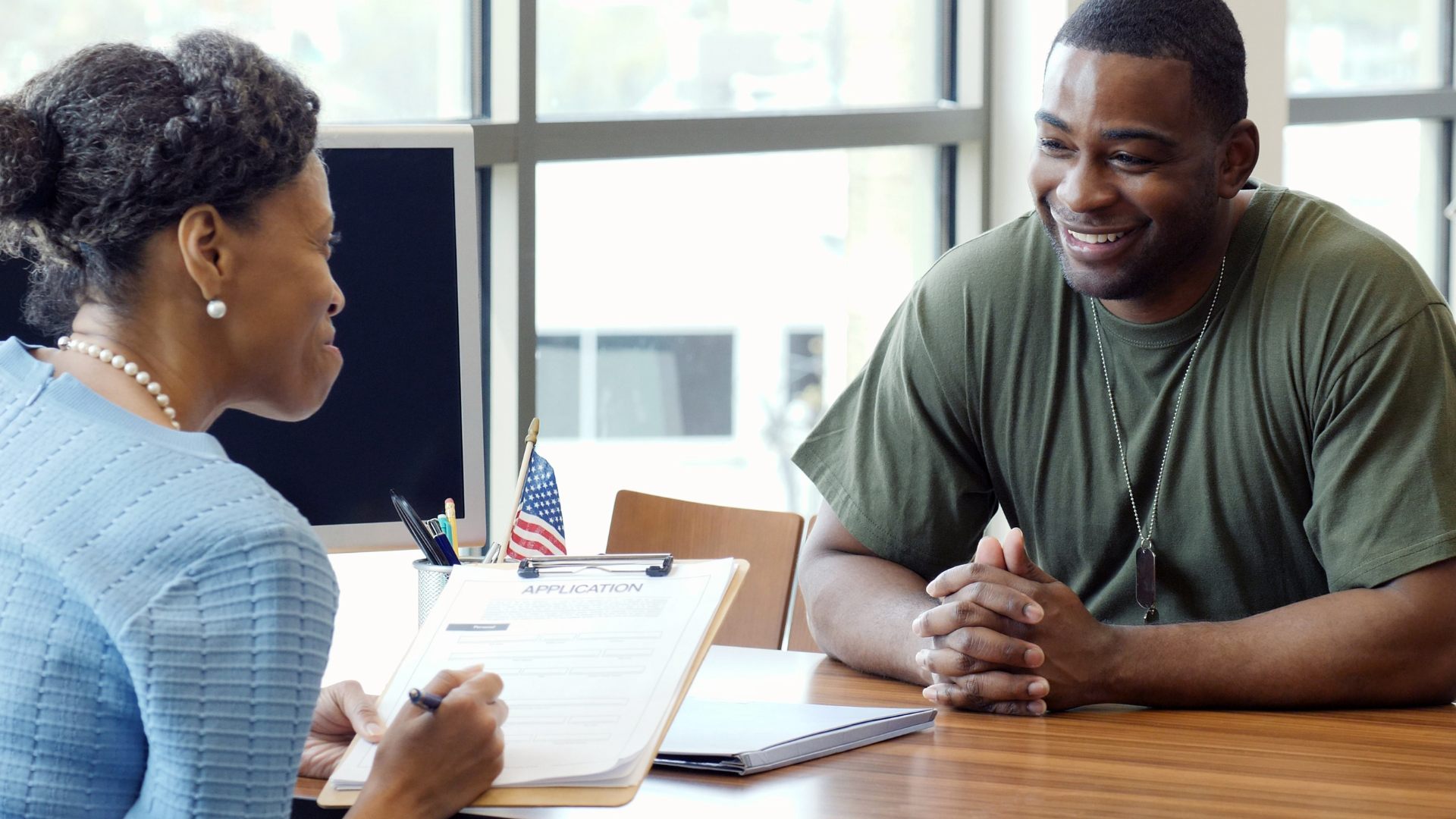 Veterans talking with a hiring manager in an article about hiring veterans in the nonprofit sector