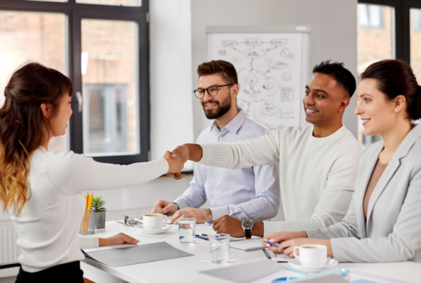 People interviewing a candidate in an article about modern hiring practices