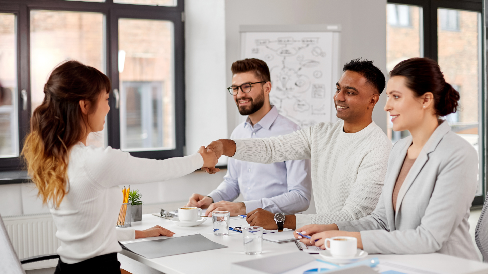 People interviewing a candidate in an article about modern hiring practices