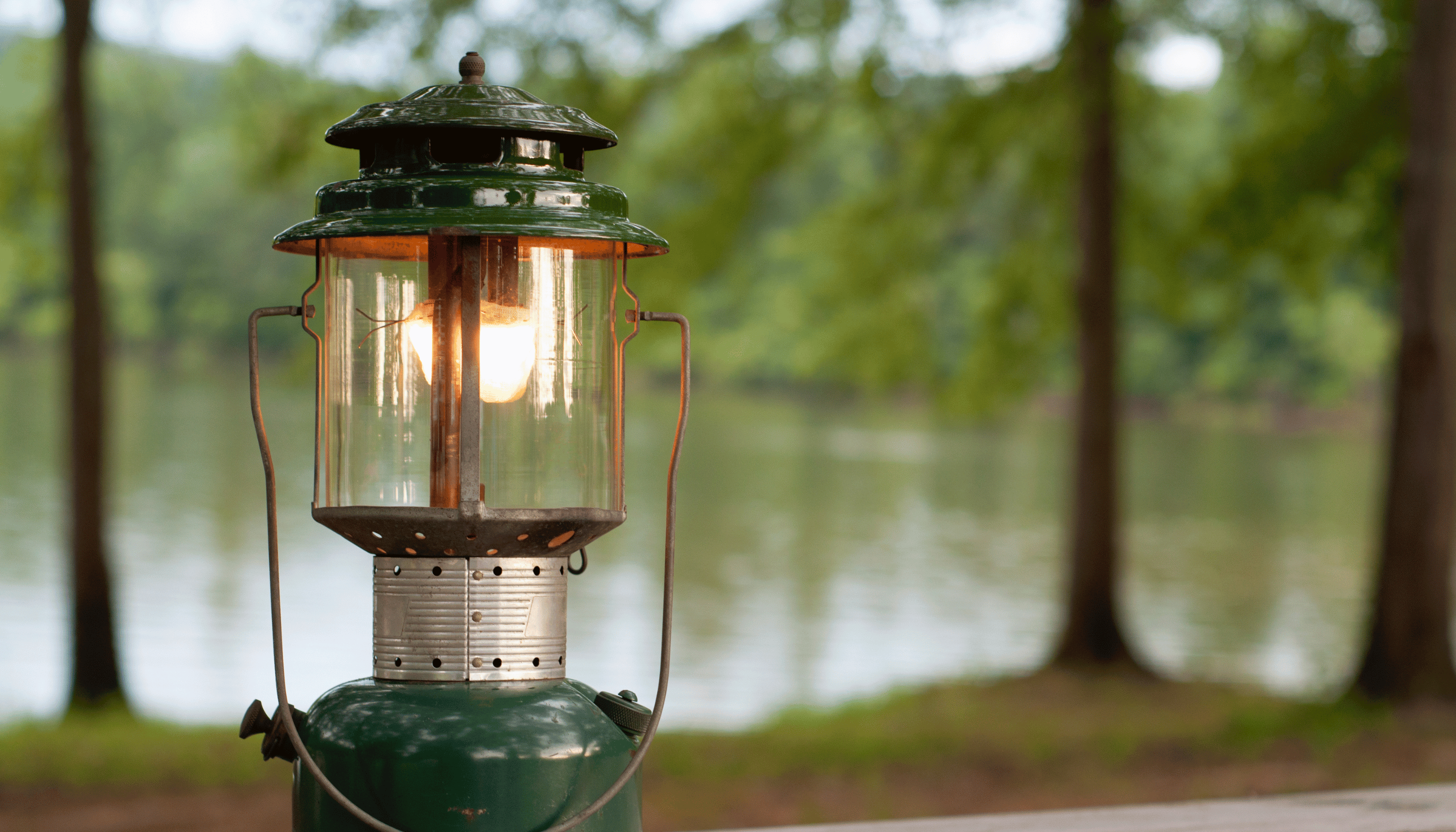 camping lantern in a forest in a press release about YMCA Camp