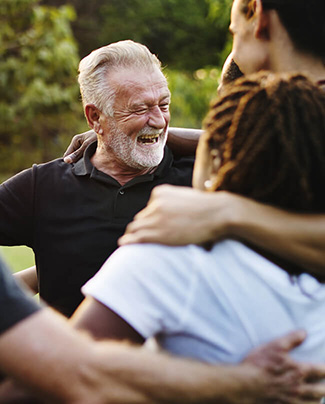 Man smiling with group